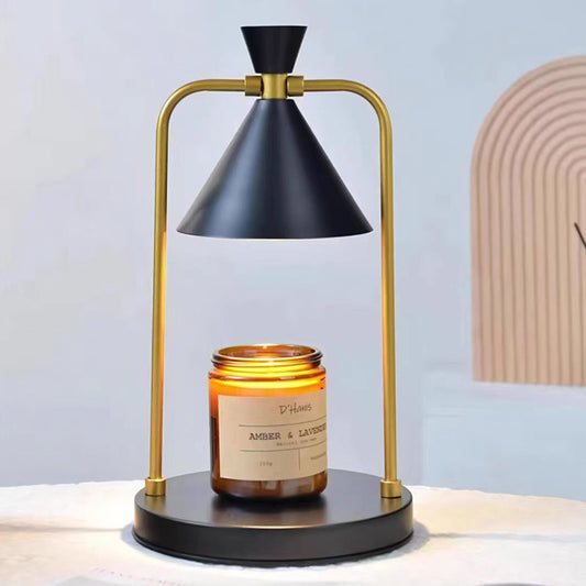Lumenest Aura candle warmer lamp in black and brass warming an amber jar candle