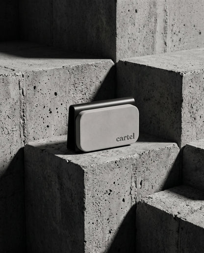 Cartel car perfume in its steel visor clip on concrete